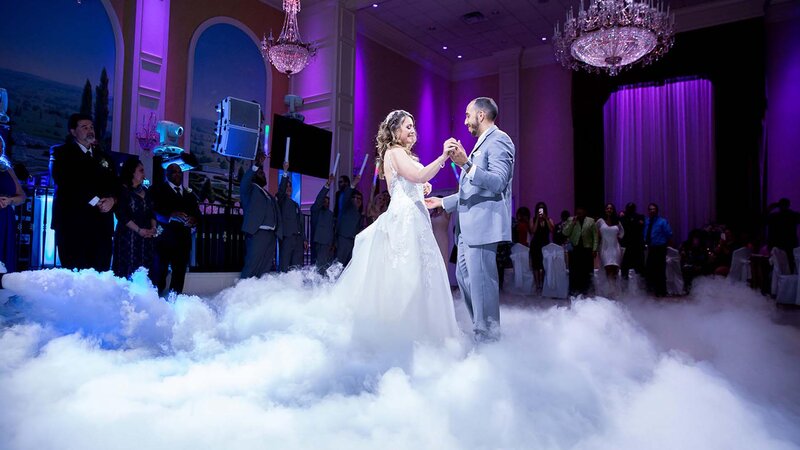 Bride & Groom dancing in ballroom with smoke machine.